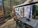 Wooden deck with table and chairs, perfect for outdoor entertaining and relaxation at 1000 Phils Creek Rd, Chapel Hill, NC 27516