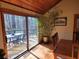 Sunny dining area with large sliding glass doors leading to outdoor deck and wooded views at 1000 Phils Creek Rd, Chapel Hill, NC 27516