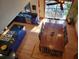 Birds-eye view of bright dining room with long table, stylish kitchen, and access to deck at 1000 Phils Creek Rd, Chapel Hill, NC 27516