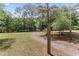 Gated gravel driveway with lush trees surrounding the entrance of a private property at 1000 Phils Creek Rd, Chapel Hill, NC 27516