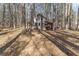 Rustic cabin nestled among mature trees, offering privacy and a natural setting at 1000 Phils Creek Rd, Chapel Hill, NC 27516