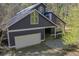 Exterior view of home featuring a two-car garage and stone walkway at 1000 Phils Creek Rd, Chapel Hill, NC 27516