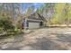 Two-story home with driveway and attached two car garage, set among tall trees at 1000 Phils Creek Rd, Chapel Hill, NC 27516