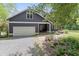 Charming home exterior featuring a garage, front door, well-maintained lawn, and a stone driveway at 1000 Phils Creek Rd, Chapel Hill, NC 27516
