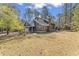 Beautiful home featuring an attached garage, a brick chimney and a grassy lawn at 1000 Phils Creek Rd, Chapel Hill, NC 27516