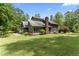 Exterior view of home with lush lawn and mature trees at 1000 Phils Creek Rd, Chapel Hill, NC 27516