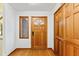 A home foyer features a front door, wood floors, and a window at 1000 Phils Creek Rd, Chapel Hill, NC 27516