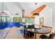Modern kitchen with blue cabinets, stainless appliances, island, and dining area at 1000 Phils Creek Rd, Chapel Hill, NC 27516