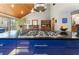 Large kitchen island with gas range, wood ceilings, open layout, with ample dining space at 1000 Phils Creek Rd, Chapel Hill, NC 27516
