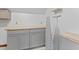 Laundry room featuring gray cabinets, wood countertop, and ironing board at 1000 Phils Creek Rd, Chapel Hill, NC 27516