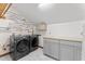 Laundry room with modern washer and dryer set and utility sink at 1000 Phils Creek Rd, Chapel Hill, NC 27516