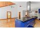 Large kitchen island with cooktop in open room with wooden floor and ceiling at 1000 Phils Creek Rd, Chapel Hill, NC 27516