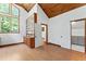 Bright living room with wood floors, wood ceiling, built-in shelves and large window at 1000 Phils Creek Rd, Chapel Hill, NC 27516