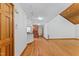 Spacious living room with wood floors, an entry door, and staircase at 1000 Phils Creek Rd, Chapel Hill, NC 27516