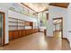 Large living room features built-in wooden shelves, hardwood floors, high ceilings and multiple windows at 1000 Phils Creek Rd, Chapel Hill, NC 27516