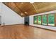 Living room has wood ceiling and floors, plus a fireplace and expansive windows for natural light at 1000 Phils Creek Rd, Chapel Hill, NC 27516