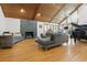 Bright living room with a stone fireplace, wood ceiling, and large windows showcasing the outdoors at 1000 Phils Creek Rd, Chapel Hill, NC 27516