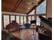 Inviting living room with vaulted wood ceilings, oversized windows, and two grand pianos at 1000 Phils Creek Rd, Chapel Hill, NC 27516
