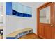 Mud room with coat rack, wooden bench and storage, next to the front door at 1000 Phils Creek Rd, Chapel Hill, NC 27516