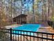 Backyard pool featuring a screened-in gazebo and set within a wooded area at 1000 Phils Creek Rd, Chapel Hill, NC 27516