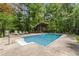 Swimming pool with cabana and surrounding trees at 1000 Phils Creek Rd, Chapel Hill, NC 27516