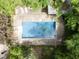 Aerial view of in-ground pool, deck, and outdoor lounge area surrounded by trees at 1000 Phils Creek Rd, Chapel Hill, NC 27516