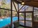 Enclosed screen porch with view of backyard pool and lounge area at 1000 Phils Creek Rd, Chapel Hill, NC 27516