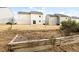 A backyard showing a garden area with light-colored home, with a chain link fence at 1012 Old Evergreen Dr, Durham, NC 27704