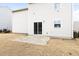 Exterior shot of home showing a small backyard with a concrete patio and sliding glass doors at 1012 Old Evergreen Dr, Durham, NC 27704