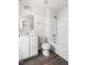 A well-lit bathroom boasts a white vanity, toilet, mirror, and shower-tub combo at 1012 Old Evergreen Dr, Durham, NC 27704