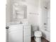 Bright bathroom featuring a vanity with a mirror, toilet, and a shower-tub combo with white tile surround at 1012 Old Evergreen Dr, Durham, NC 27704