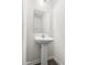 Bathroom with a pedestal sink, large mirror, and updated fixtures at 1012 Old Evergreen Dr, Durham, NC 27704