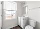 Bathroom featuring a window view, vanity, mirror, toilet, and wood-look vinyl flooring at 1012 Old Evergreen Dr, Durham, NC 27704