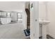 Entryway with stairway and half bathroom, featuring a pedestal sink and sleek mirror at 1012 Old Evergreen Dr, Durham, NC 27704