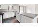 Bright kitchen featuring an island, stainless steel appliances, and white cabinetry at 1012 Old Evergreen Dr, Durham, NC 27704