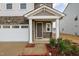 Close-up of a home's front porch with stone details and manicured garden beds at 1016 Matterhorn Dr, Fuquay Varina, NC 27526