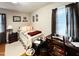 Cozy bedroom with hardwood floors, a bed, a desk, and neutral-colored walls at 107 N Pearl St, Princeton, NC 27569