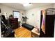 Bedroom with a treadmill, a dresser, and a window with blinds at 107 N Pearl St, Princeton, NC 27569