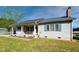Charming single-story home featuring a covered front porch, light siding and green shutters at 107 N Pearl St, Princeton, NC 27569