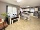 Bright kitchen featuring white cabinets, neutral walls, a breakfast bar and views to an eating area at 107 N Pearl St, Princeton, NC 27569