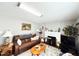 Living room featuring hardwood floors, a white painted fireplace, and grey walls at 107 N Pearl St, Princeton, NC 27569