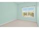 Neutral bedroom with wall-to-wall carpeting and a window allowing for plenty of natural light at 1103 Weston Green Loop, Cary, NC 27513