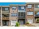 Townhome complex featuring brick and siding exteriors, individual garages, and screened-in porches at 1103 Weston Green Loop, Cary, NC 27513