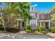 Charming brick townhouse with manicured landscaping, covered entrance, and a beautifully blue summer sky at 1103 Weston Green Loop, Cary, NC 27513