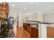Open kitchen featuring stainless steel appliances, granite countertops, and hardwood floors at 1103 Weston Green Loop, Cary, NC 27513