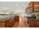 Kitchen featuring stainless steel appliances, granite countertops, and wood cabinets at 1103 Weston Green Loop, Cary, NC 27513