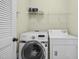 This laundry room showcases modern, front-loading machines and ample storage shelves for detergents and supplies at 1103 Weston Green Loop, Cary, NC 27513