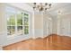Sunlit living room featuring hardwood floors, an entry door, and a large window at 1103 Weston Green Loop, Cary, NC 27513