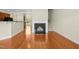 Open-concept living area with a fireplace, hardwood floors, and access to the staircase at 1103 Weston Green Loop, Cary, NC 27513