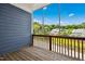 Cozy screened porch with wood flooring, wood railing and a serene view of the surrounding landscape at 1103 Weston Green Loop, Cary, NC 27513